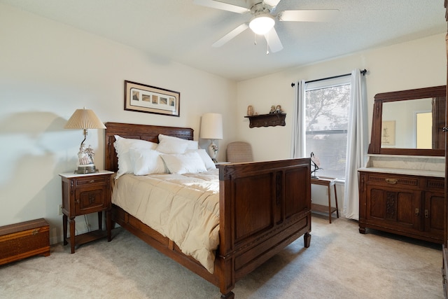 bedroom with ceiling fan and light colored carpet