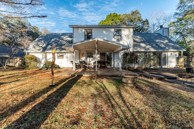 rear view of property featuring ceiling fan, a yard, and a wooden deck