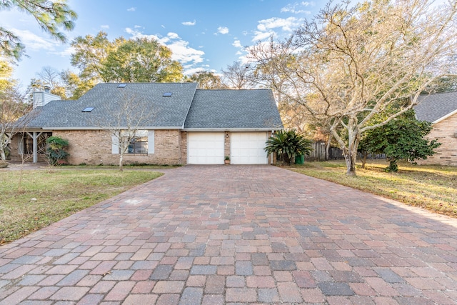 view of front of property featuring a garage and a front yard