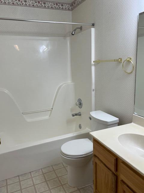 full bathroom with toilet, bathing tub / shower combination, and vanity