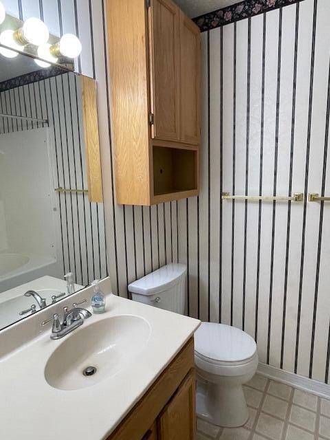 bathroom featuring toilet and vanity