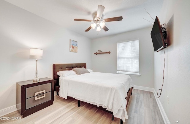 bedroom with ceiling fan and light hardwood / wood-style floors