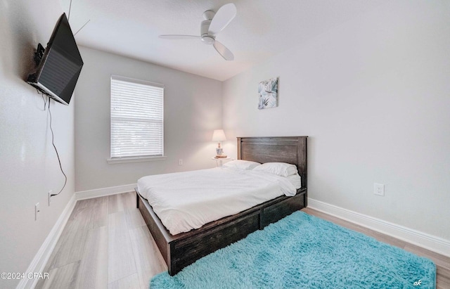 bedroom with ceiling fan and hardwood / wood-style floors