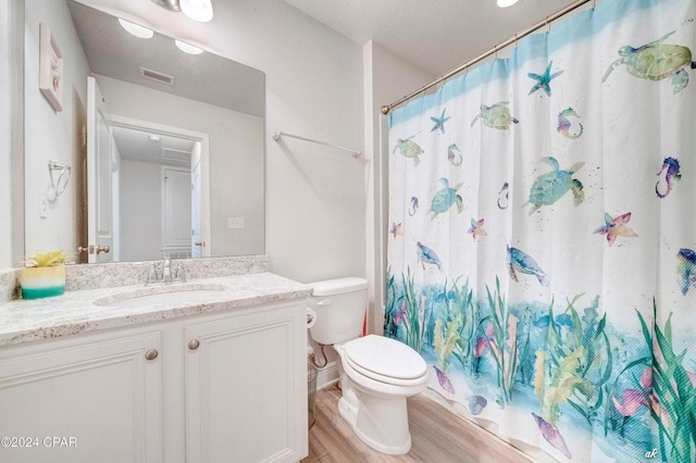 bathroom with hardwood / wood-style flooring, vanity, toilet, and a shower with shower curtain