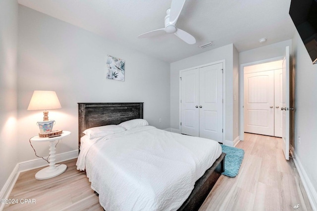 bedroom with ceiling fan, a closet, and light hardwood / wood-style flooring