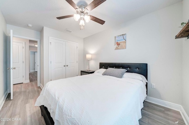 bedroom featuring hardwood / wood-style floors, a closet, and ceiling fan