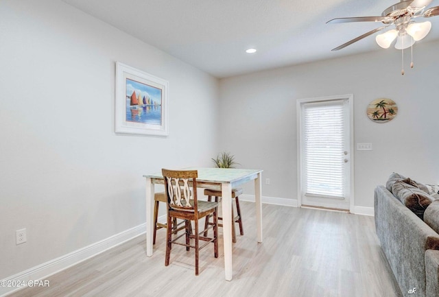 dining area with ceiling fan and light hardwood / wood-style floors