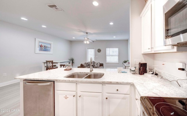 kitchen with ceiling fan, sink, stainless steel dishwasher, light hardwood / wood-style floors, and white cabinets