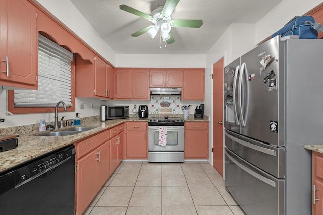 kitchen featuring light stone countertops, ceiling fan, sink, stainless steel appliances, and light tile patterned flooring