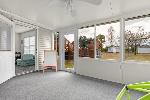 unfurnished sunroom with a wealth of natural light and ceiling fan