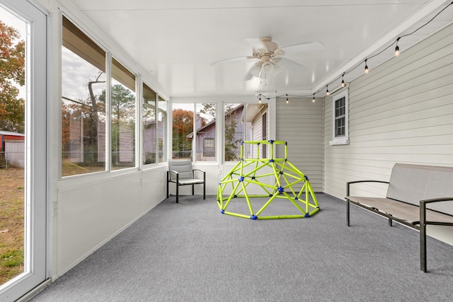 unfurnished sunroom with a wealth of natural light and ceiling fan