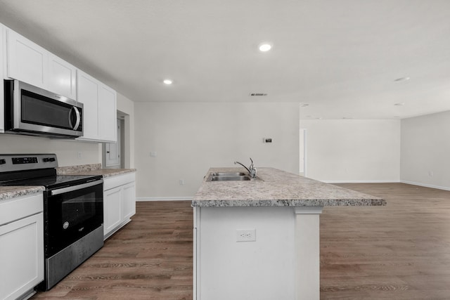 kitchen with a center island with sink, sink, white cabinetry, and stainless steel appliances