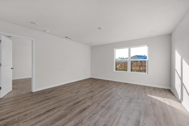 unfurnished room featuring light hardwood / wood-style floors