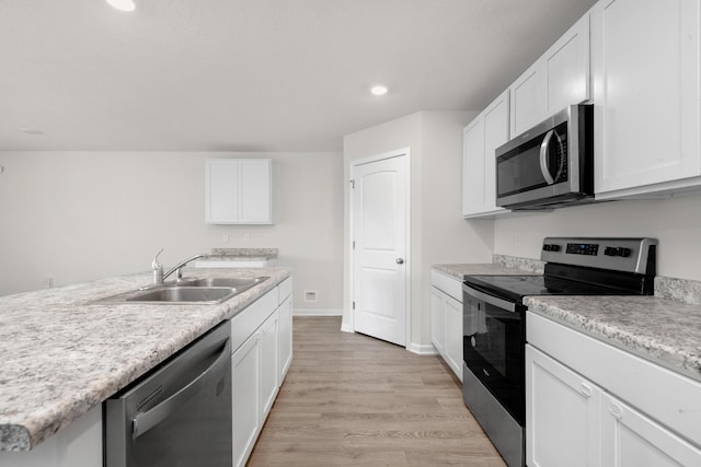 kitchen with sink, light wood-type flooring, white cabinetry, and stainless steel appliances