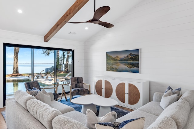 living room with hardwood / wood-style floors, lofted ceiling with beams, ceiling fan, and a water view