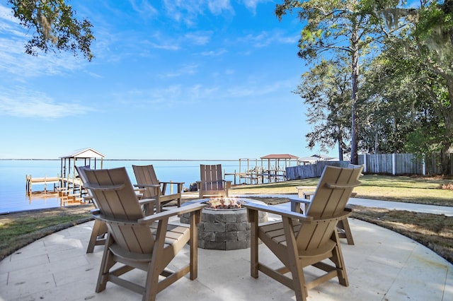 view of patio / terrace featuring a water view and an outdoor fire pit