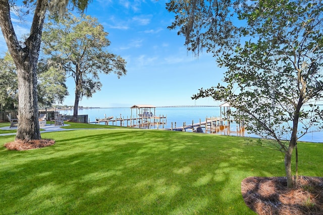 view of yard with a boat dock and a water view