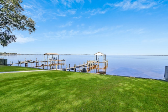 view of dock featuring a yard and a water view