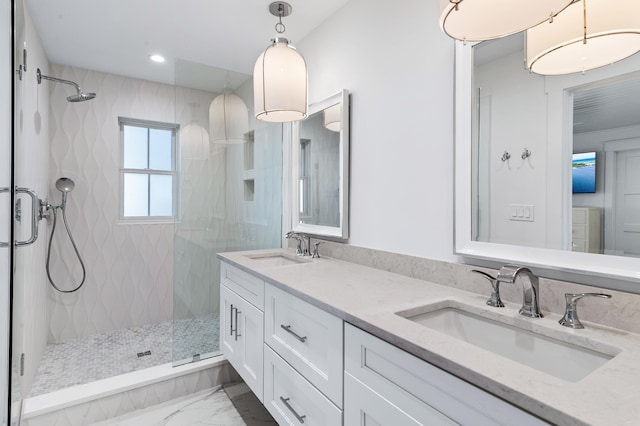 bathroom featuring tiled shower and vanity