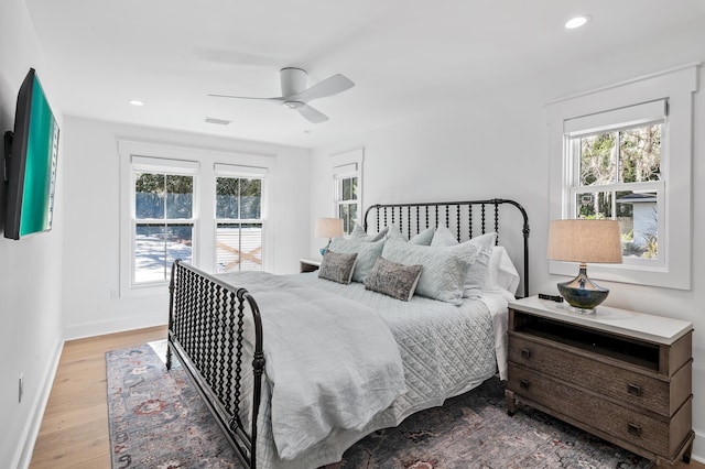 bedroom with light hardwood / wood-style floors and ceiling fan