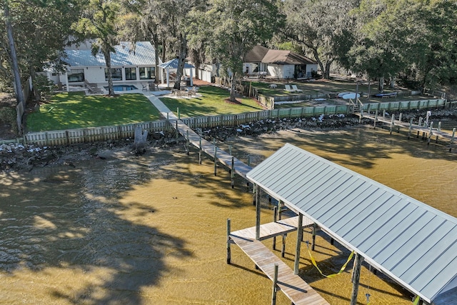 view of home's community with a yard and a boat dock