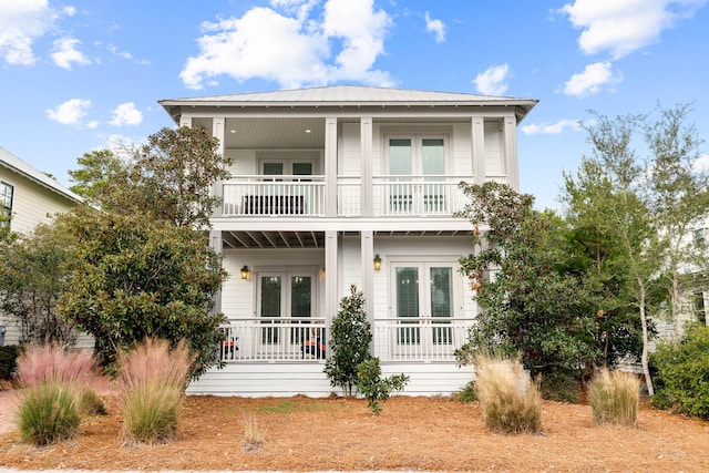 back of house with french doors and a balcony