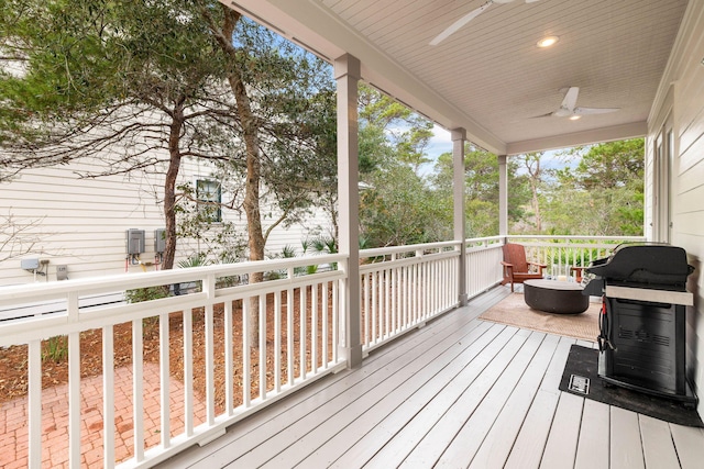 deck with area for grilling and ceiling fan