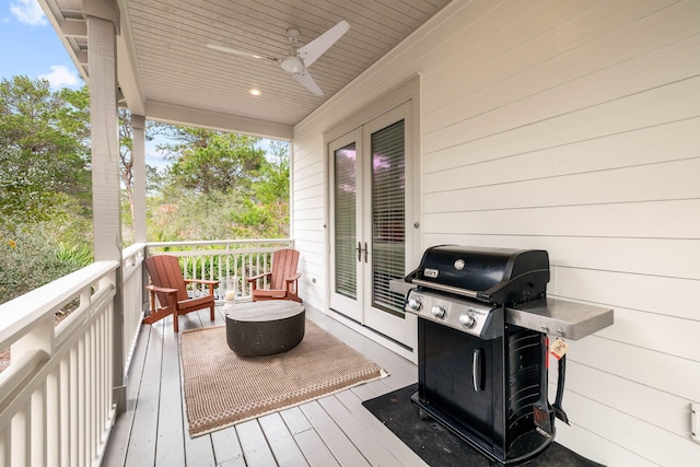 deck featuring a grill, ceiling fan, and french doors