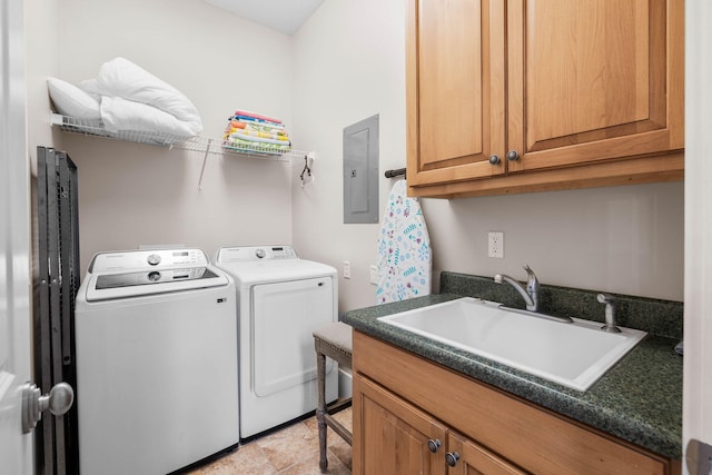 laundry room featuring washer and clothes dryer, electric panel, sink, and cabinets