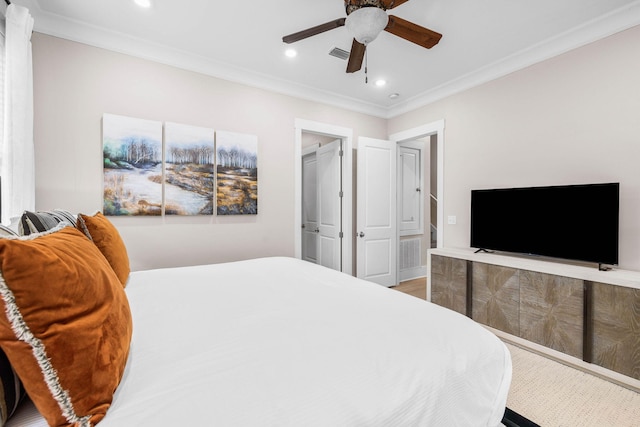 bedroom with hardwood / wood-style floors, ceiling fan, crown molding, and a closet