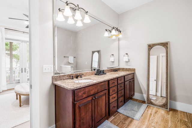 bathroom with ceiling fan, hardwood / wood-style floors, and vanity