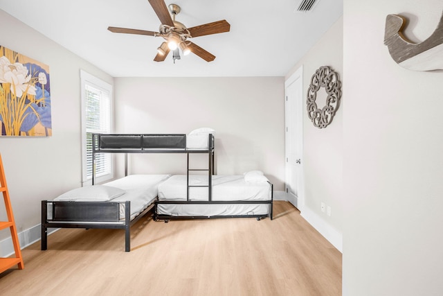 bedroom with ceiling fan and light hardwood / wood-style flooring