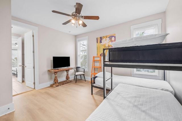 bedroom with ceiling fan and light hardwood / wood-style floors