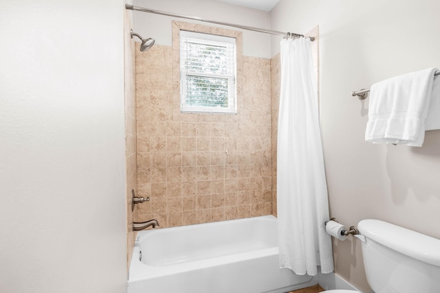 bathroom with toilet and shower / tub combo with curtain