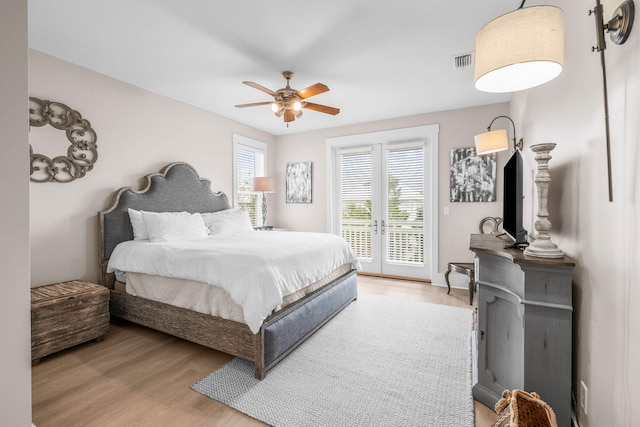 bedroom with access to exterior, ceiling fan, light hardwood / wood-style flooring, and french doors