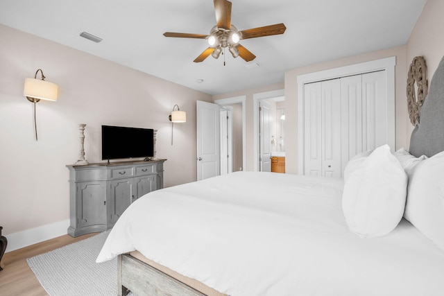 bedroom featuring a closet, light hardwood / wood-style flooring, and ceiling fan