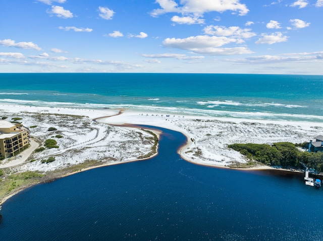 birds eye view of property with a water view and a beach view