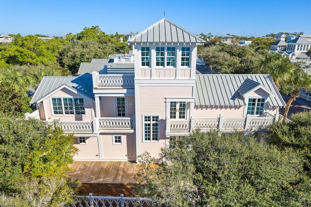 back of property featuring a balcony