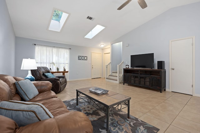 tiled living room with ceiling fan and lofted ceiling