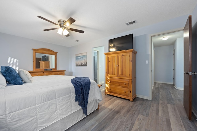 bedroom featuring ceiling fan, a textured ceiling, and hardwood / wood-style flooring