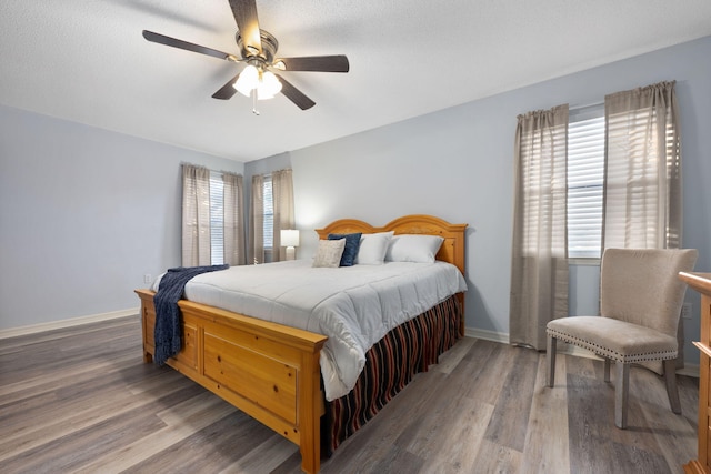 bedroom featuring ceiling fan and dark hardwood / wood-style floors