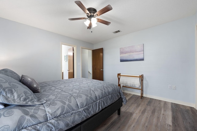 bedroom featuring ceiling fan, hardwood / wood-style floors, and ensuite bathroom