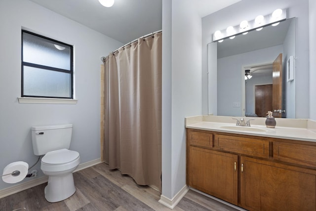 bathroom with wood-type flooring, toilet, vanity, and a shower with curtain