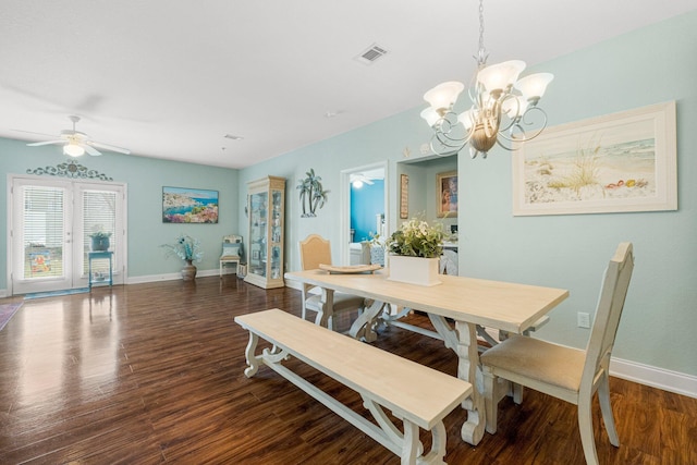 dining area with dark hardwood / wood-style flooring and ceiling fan with notable chandelier