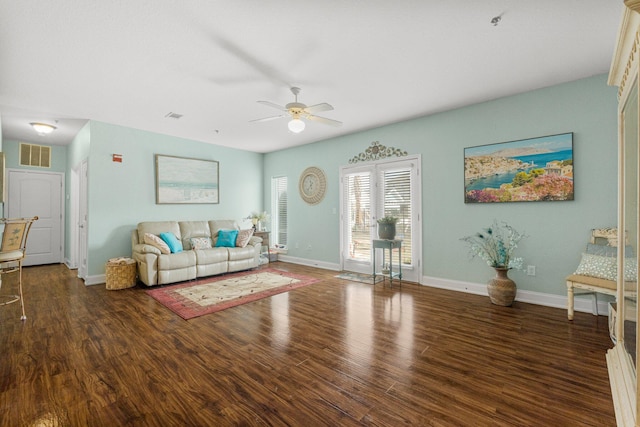 living room with ceiling fan and dark hardwood / wood-style flooring