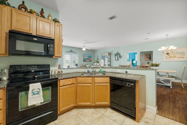 kitchen featuring kitchen peninsula, ceiling fan with notable chandelier, sink, black appliances, and light tile patterned floors