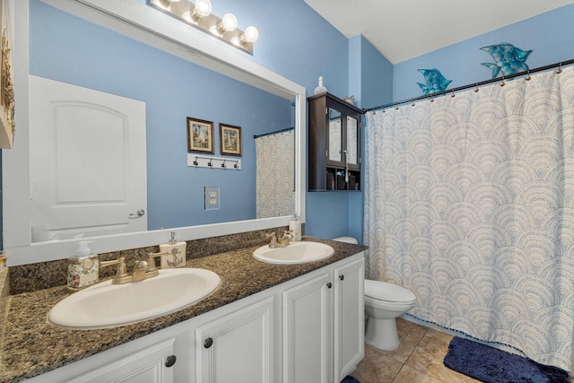 bathroom with tile patterned floors, vanity, and toilet