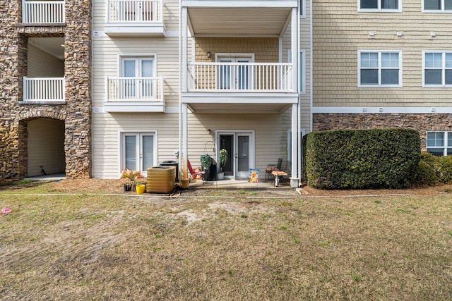 rear view of property with cooling unit and a patio