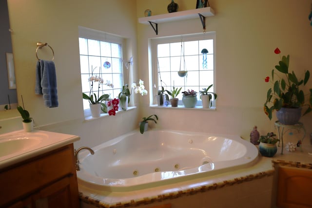 bathroom featuring vanity and a relaxing tiled tub