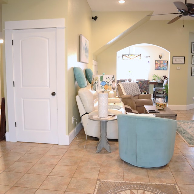 living room featuring light tile patterned floors and ceiling fan